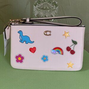 COACH STICKER PRINT WRISTLET:NWT CHALK/MULTI  GLOVETANNED LEATHER